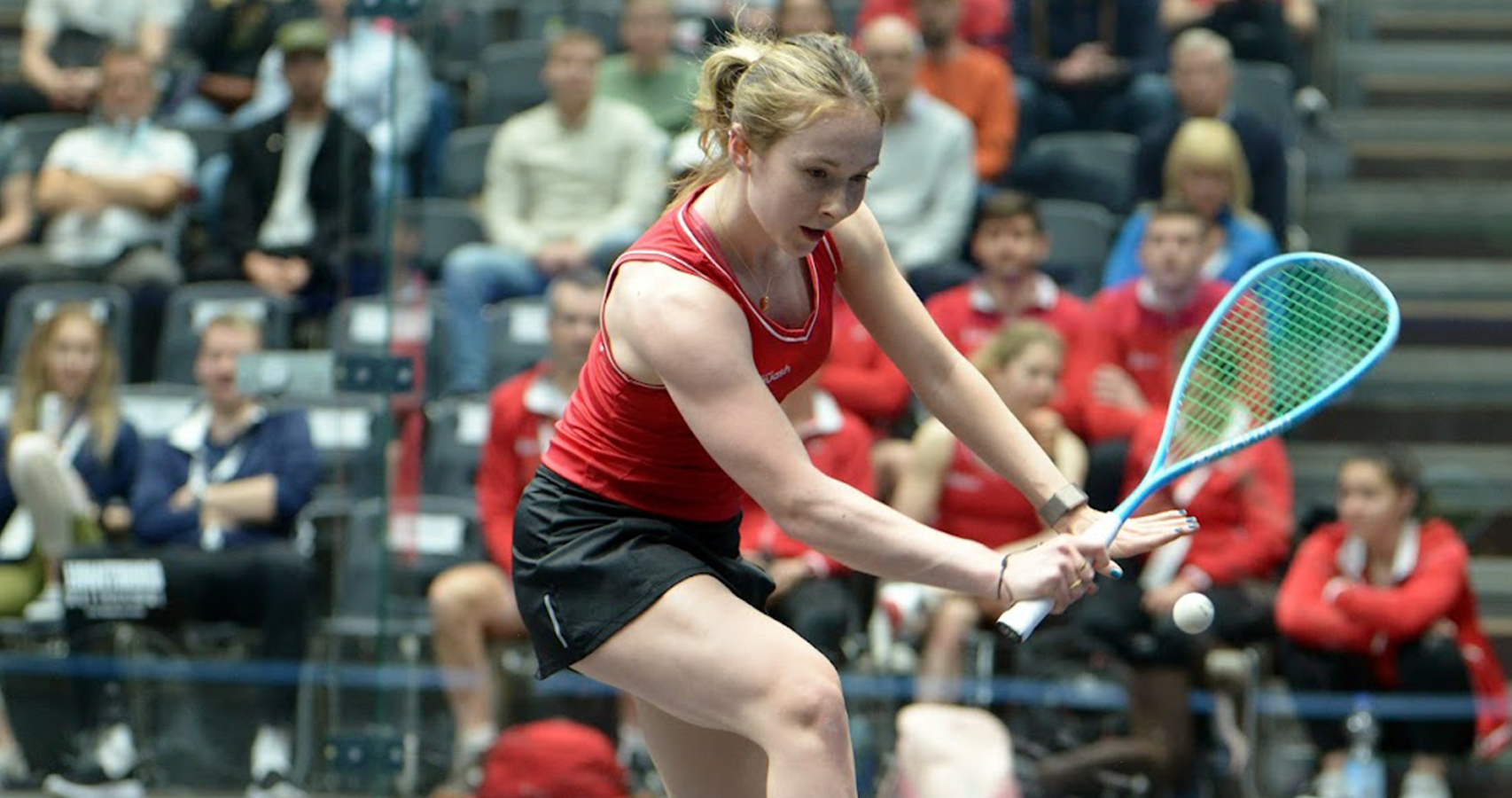 Lucy Turmel on court playing squash